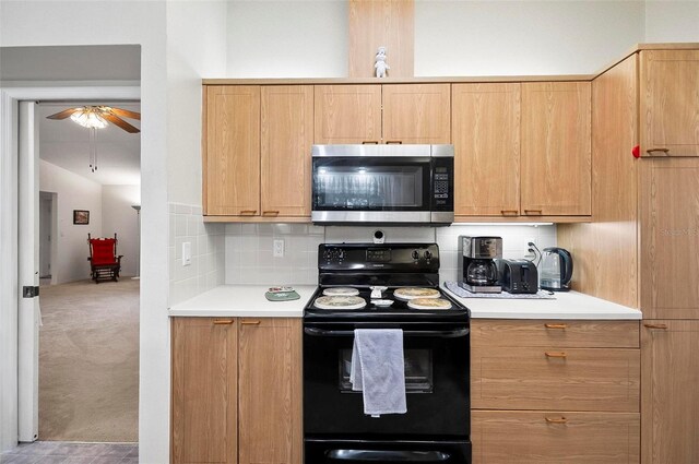 kitchen with ceiling fan, backsplash, carpet flooring, black electric range, and light brown cabinets