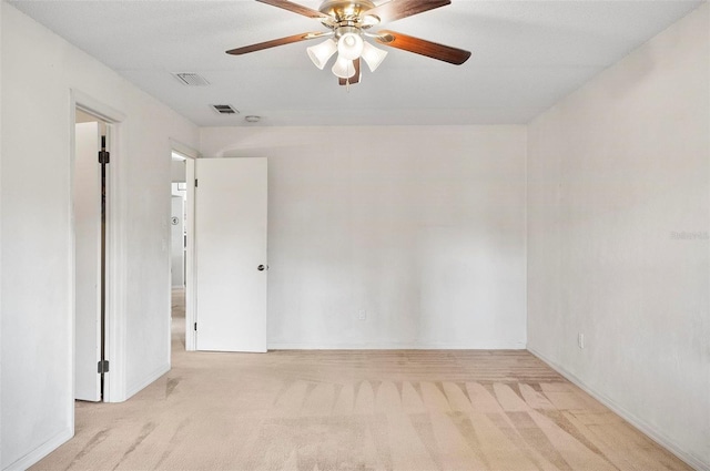 empty room with light colored carpet and ceiling fan