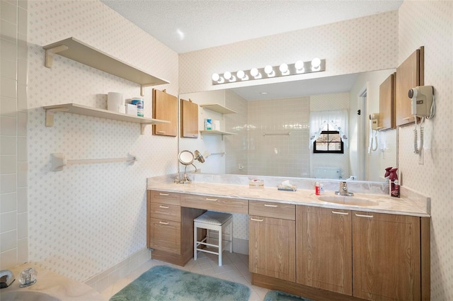 bathroom with tile patterned flooring, vanity, and walk in shower