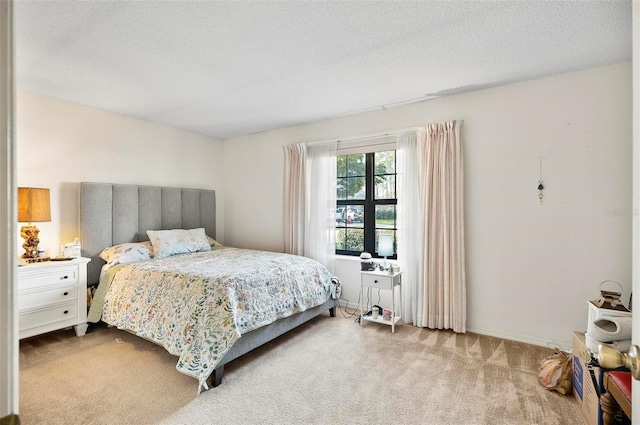 carpeted bedroom featuring a textured ceiling