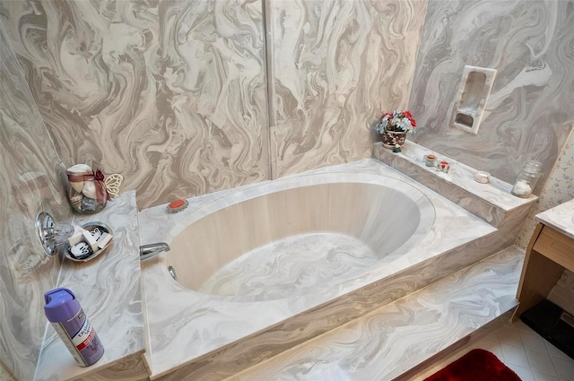 bathroom featuring tile patterned flooring, vanity, and a washtub