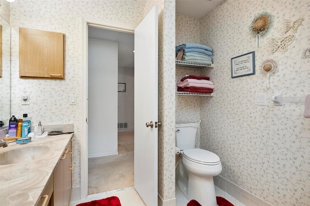 bathroom with vanity, tile patterned floors, and toilet