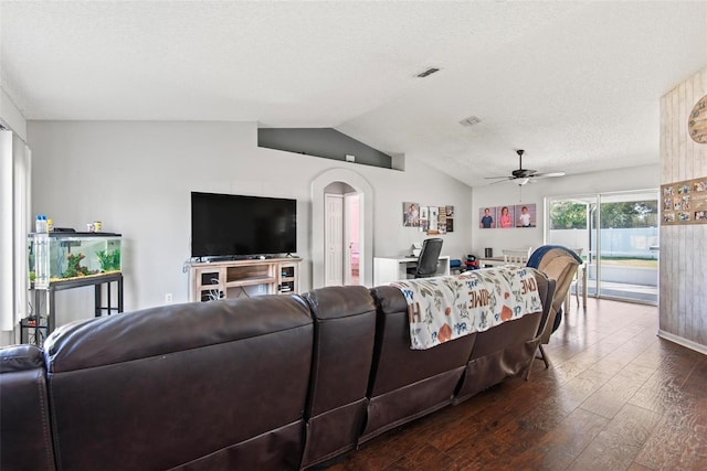 living room featuring ceiling fan, lofted ceiling, dark wood-type flooring, and a textured ceiling