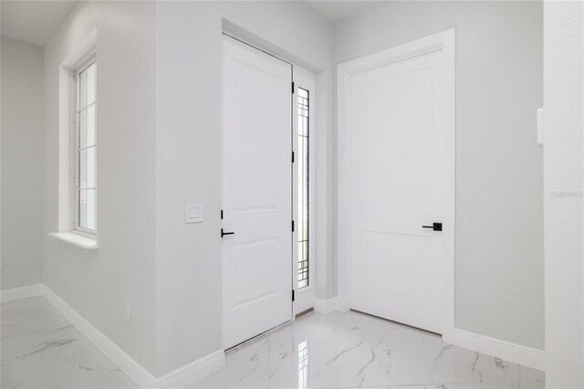 20 Pine Hill Ln, Palm Coast, FL 32164 - foyer entrance featuring baseboards, marble finish floor, and a healthy amount of sunlight