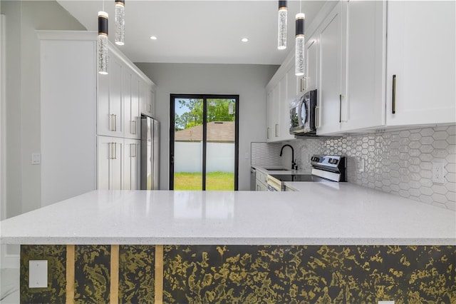 20 Pine Hill Ln, Palm Coast, FL 32164 - kitchen with decorative backsplash, white cabinetry, light stone counters, a sink, and appliances with stainless steel finishes