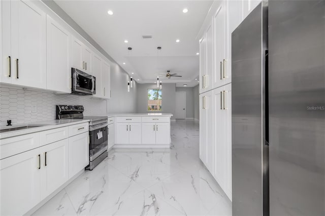 20 Pine Hill Ln, Palm Coast, FL 32164 - kitchen with recessed lighting, white cabinetry, a peninsula, and stainless steel appliances