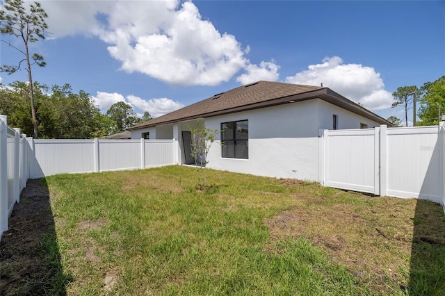 20 Pine Hill Ln, Palm Coast, FL 32164 - rear view of property featuring a fenced backyard, stucco siding, and a yard