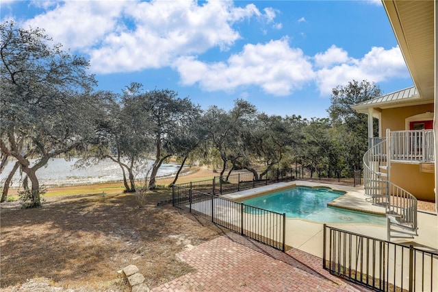 view of pool with a patio area and a water view