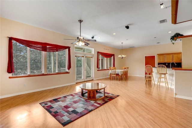 living room with sink, light hardwood / wood-style floors, french doors, and ceiling fan