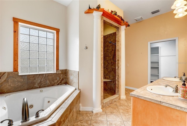 bathroom featuring vanity, shower with separate bathtub, tile patterned flooring, and ornate columns