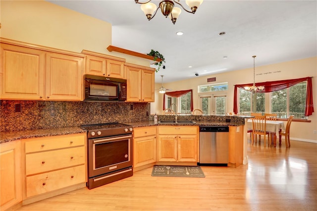 kitchen featuring sink, decorative light fixtures, light brown cabinets, a notable chandelier, and stainless steel appliances