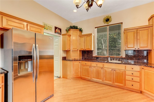 kitchen with sink, stainless steel fridge with ice dispenser, light hardwood / wood-style flooring, light brown cabinets, and backsplash