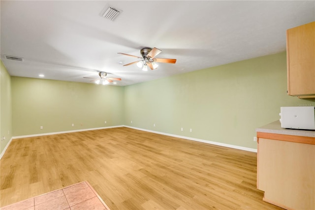 unfurnished living room with ceiling fan and light hardwood / wood-style flooring