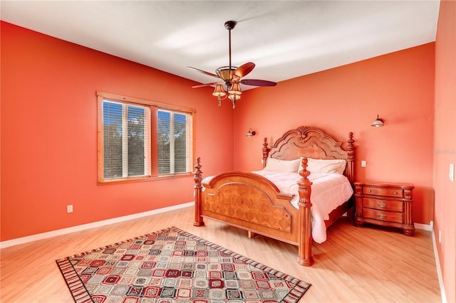 bedroom with hardwood / wood-style flooring and ceiling fan