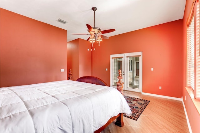 bedroom featuring wood-type flooring, access to outside, and ceiling fan