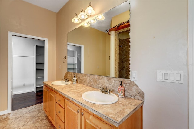 bathroom featuring vanity, decorative backsplash, and tile patterned floors