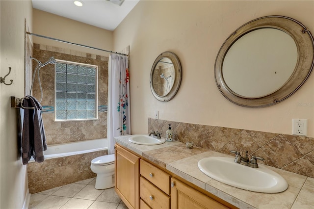 full bathroom featuring tile patterned flooring, vanity, toilet, and shower / bath combo with shower curtain