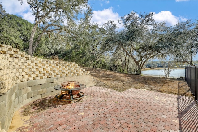 view of patio / terrace with a water view and a fire pit