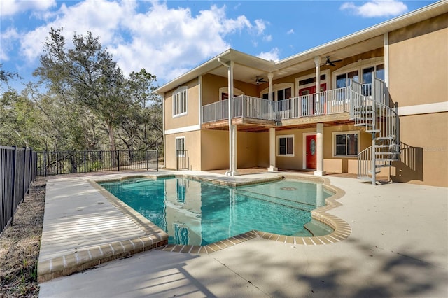 view of swimming pool featuring ceiling fan and a patio area