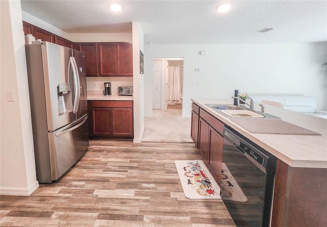 kitchen featuring sink, light hardwood / wood-style flooring, dishwasher, stainless steel refrigerator with ice dispenser, and a textured ceiling