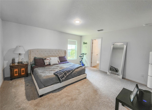 carpeted bedroom with a textured ceiling