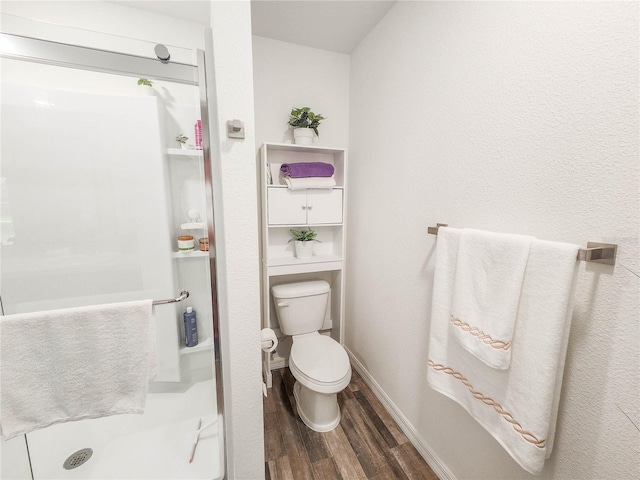 bathroom with wood-type flooring and toilet