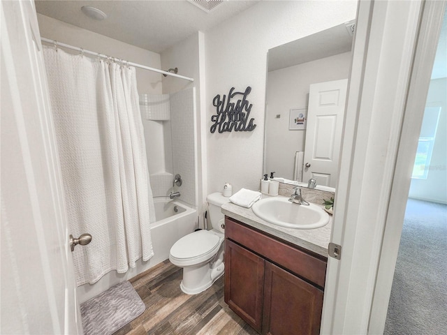 full bathroom with wood-type flooring, vanity, shower / tub combo with curtain, and toilet