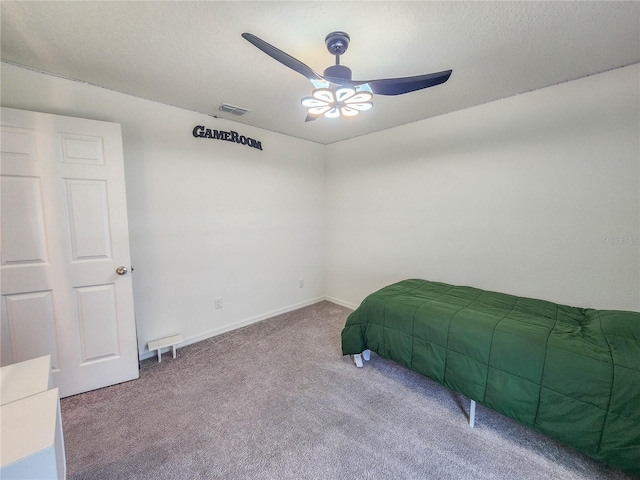 carpeted bedroom with a textured ceiling and ceiling fan