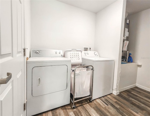 laundry room with dark hardwood / wood-style floors and washer and clothes dryer