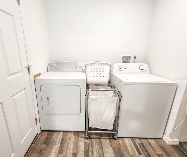 laundry area featuring dark hardwood / wood-style floors and washer and clothes dryer