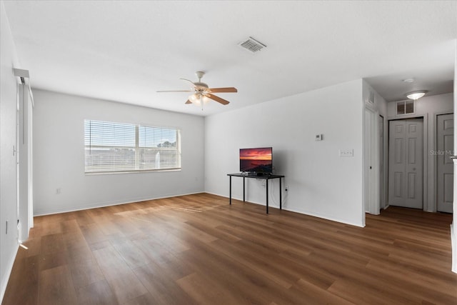 unfurnished living room with ceiling fan and dark hardwood / wood-style flooring