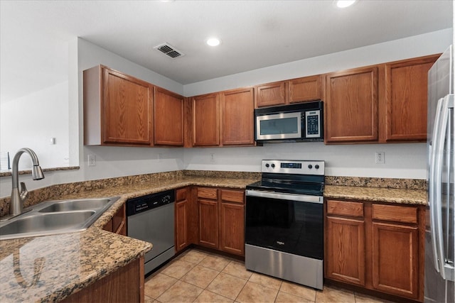 kitchen featuring sink, light tile patterned flooring, and appliances with stainless steel finishes