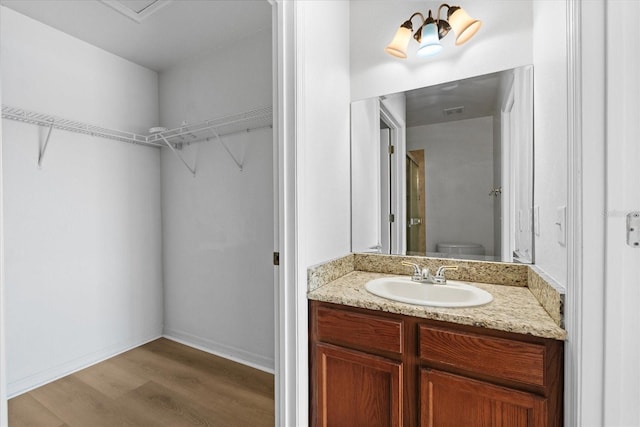 bathroom featuring hardwood / wood-style flooring, vanity, and toilet