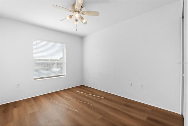 spare room featuring wood-type flooring and ceiling fan