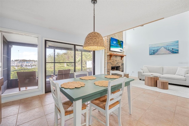 dining space with a textured ceiling and a fireplace