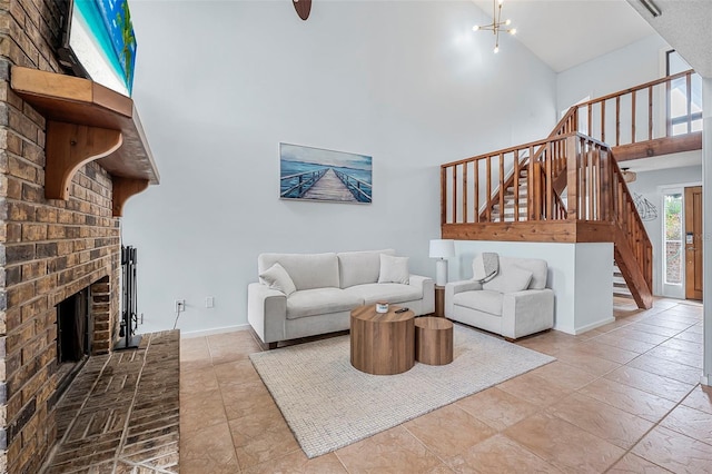 living room featuring a high ceiling, a notable chandelier, and a fireplace