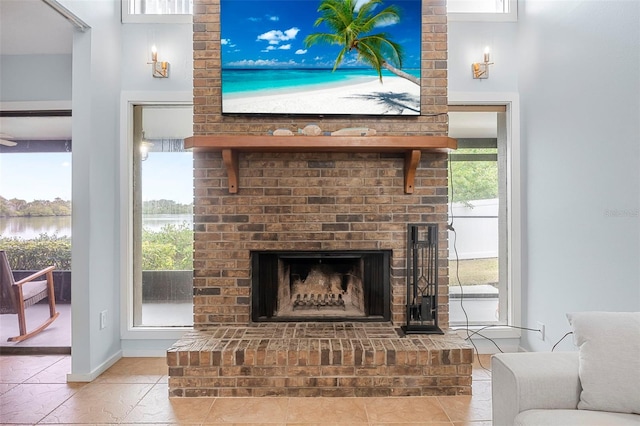 living room featuring a fireplace and a water view