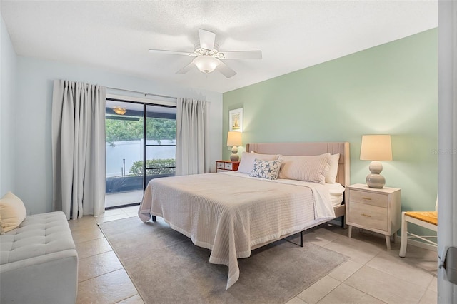 tiled bedroom with a textured ceiling, access to exterior, and ceiling fan