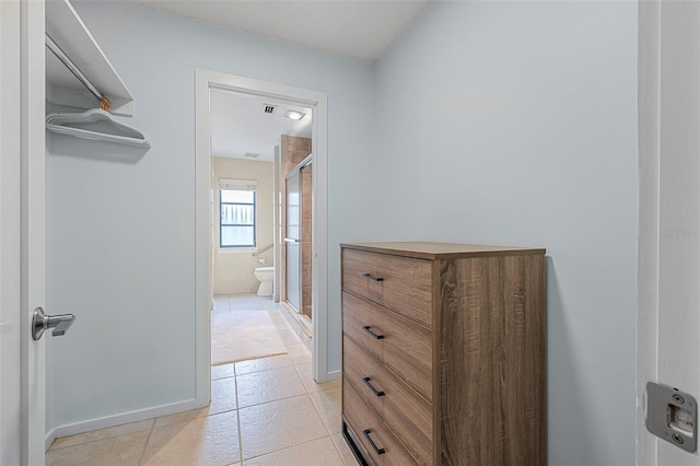 spacious closet featuring light tile patterned floors