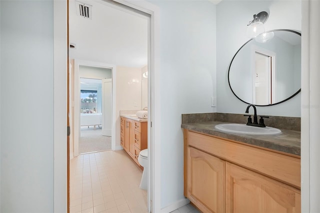 bathroom with vanity and toilet