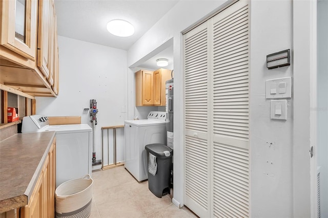 laundry room featuring washing machine and dryer and cabinets