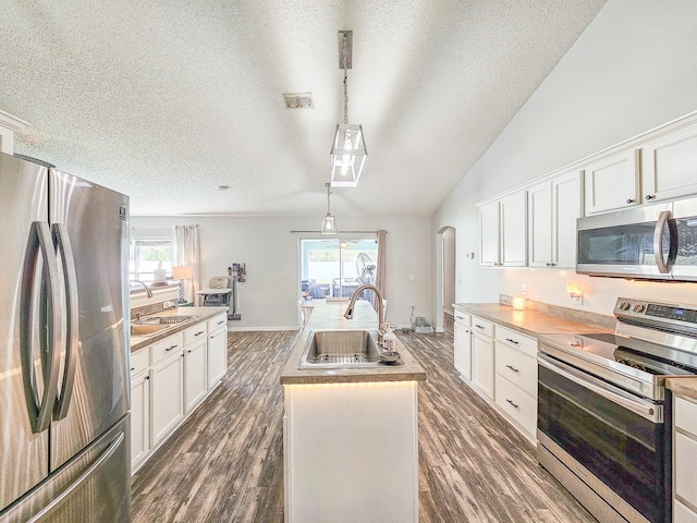 kitchen featuring pendant lighting, sink, white cabinets, and appliances with stainless steel finishes