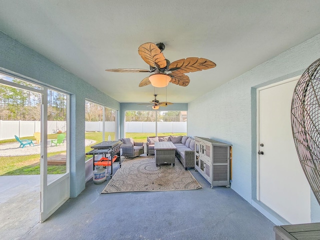 sunroom featuring ceiling fan