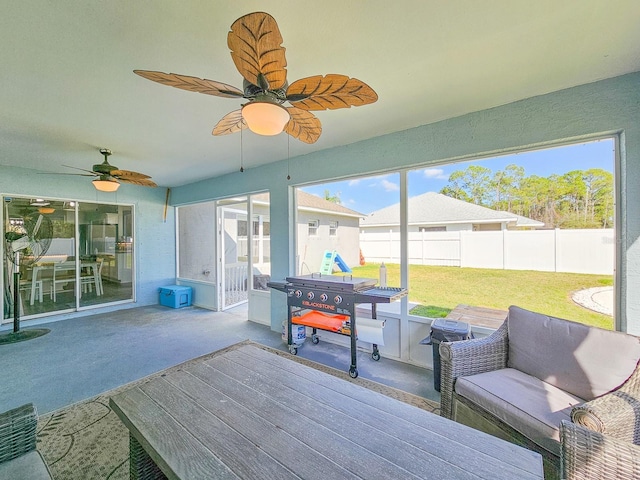 sunroom featuring ceiling fan