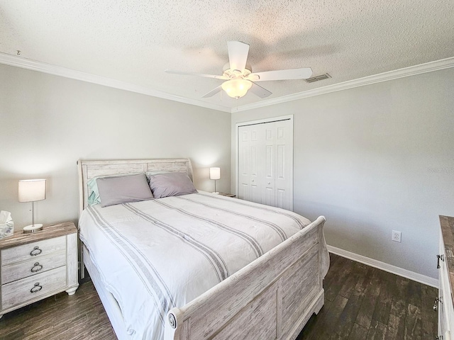 bedroom featuring ornamental molding, a textured ceiling, dark hardwood / wood-style flooring, and a closet