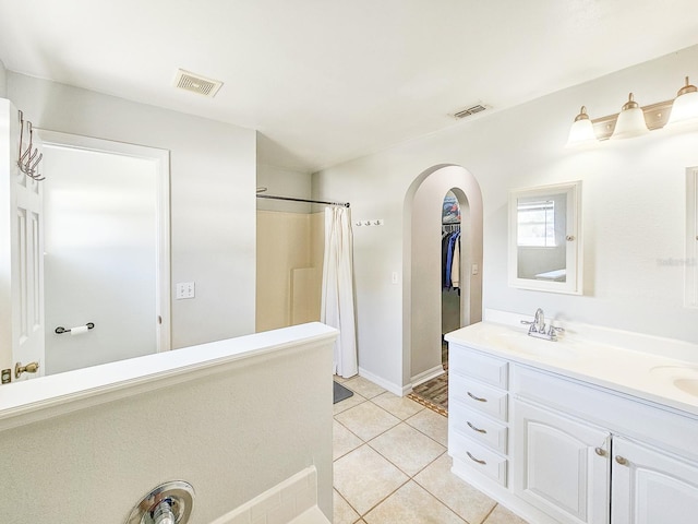 bathroom featuring vanity, curtained shower, and tile patterned flooring