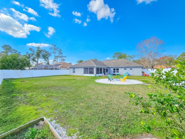 rear view of house with a yard and a patio