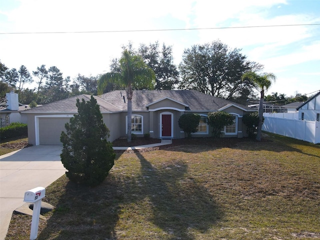 ranch-style house featuring a garage and a front lawn