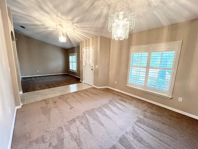 unfurnished room featuring tile patterned floors, a chandelier, and a textured ceiling