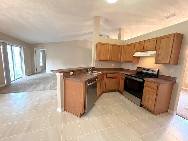 kitchen with lofted ceiling, sink, light tile patterned floors, kitchen peninsula, and stainless steel appliances